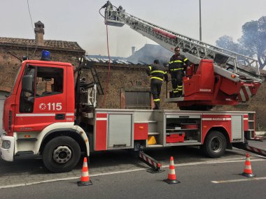 İtfaiyeciler bir eski evinde bir yangın söndürmek için meşgul