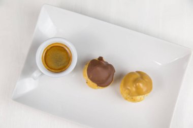 bigne' ve beyaz çanak üzerinde kahve