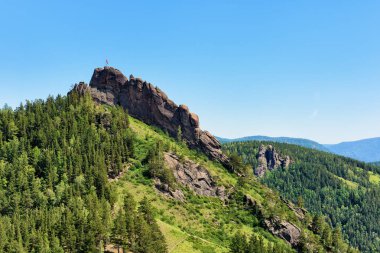 Takmak rock massif. Fanciful rocks in June afternoon. Stolby Nature Sanctuary (Pillars). Krasnoyarsk region. Russia clipart