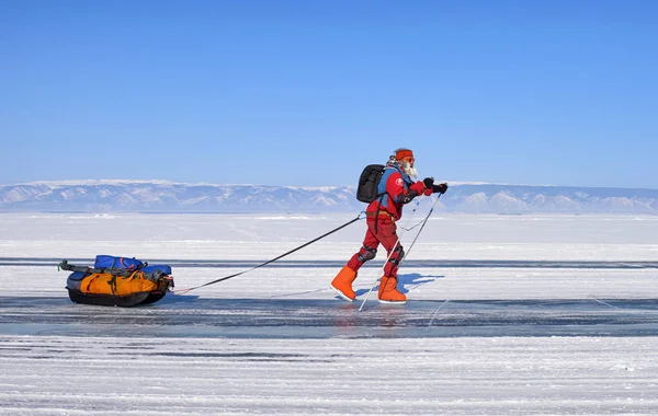 LAKE BAIKAL, IRKUTSK REGION, RUSSIA - March 08, 2017: Mature man on skates is actively moving along icy road — Stock Photo, Image