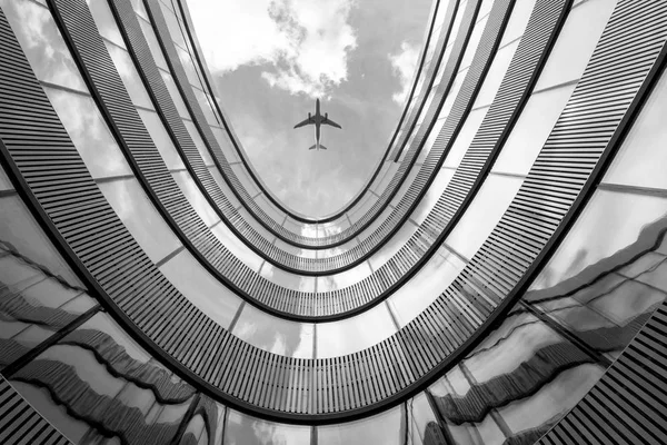 Flying airplane and modern architecture building — Stock Photo, Image