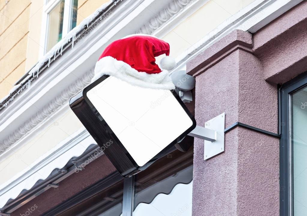 Company signage decorated with Santa hat during Christmas