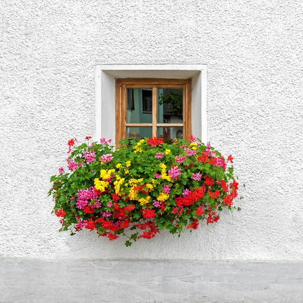 Traditional Austrian window with blooming summer flowers — Stock Photo, Image