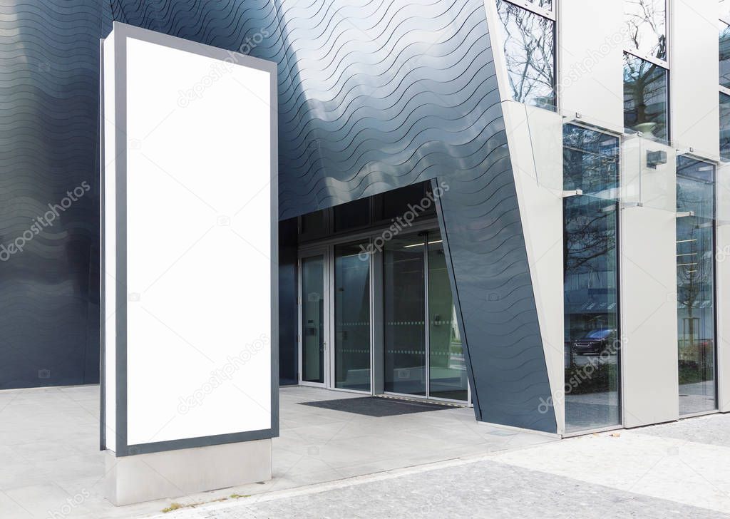 Blank standing outdoor billboard with white copy space to add multiple company names and logos with modern office building in background