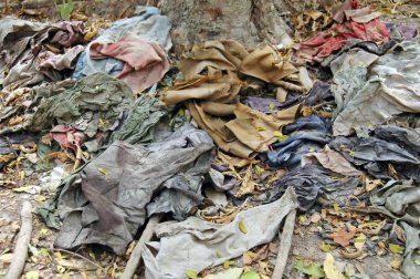 Clothes in the Killing Fields, a memorial to the victims.  clipart