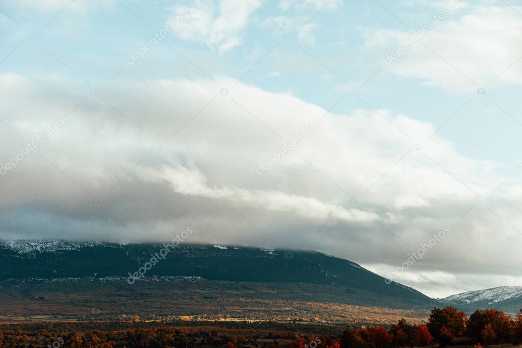 Big clouds covered the winter mountains