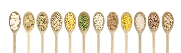 Variety of raw legumes and rices in spoons - white background — Stock Photo, Image