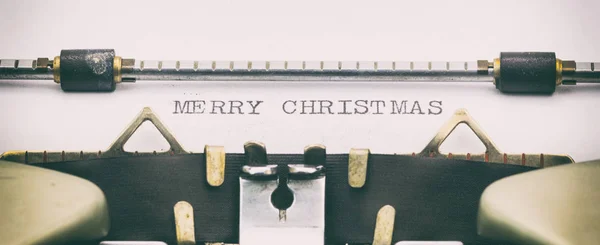 MERRY CHRISTMAS in capital letters on a typewriter sheet — Stock Photo, Image