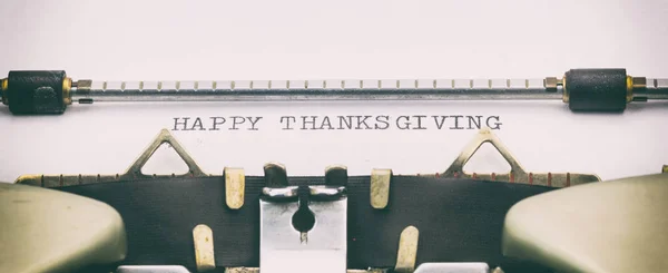 HAPPY THANKS GIVING in capital letters on a typewriter sheet