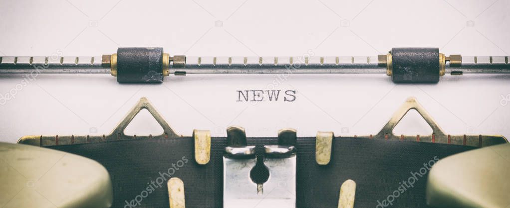 NEWS word in capital letters on a white sheet