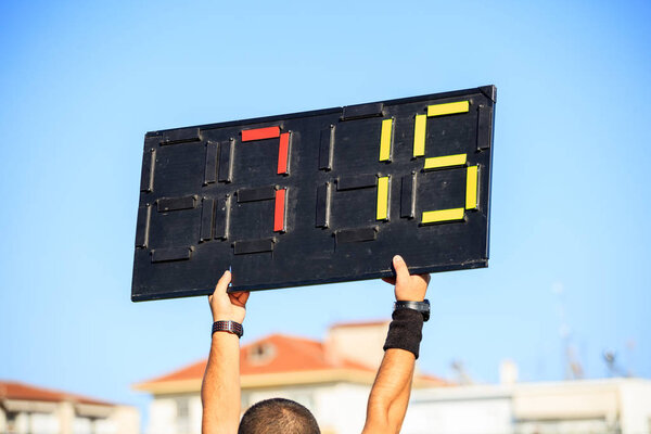 Soccer (football) referee assistant with board substitution