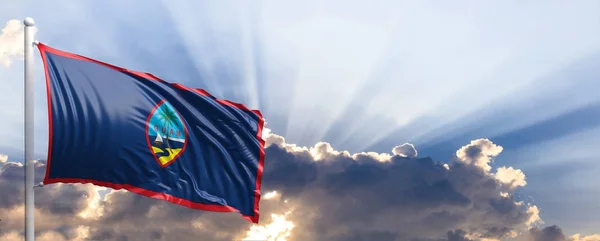 De vlag van Guam op blauwe hemel. 3D illustratie — Stockfoto