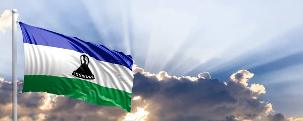 Flaga Lesotho na błękitne niebo. ilustracja 3D — Zdjęcie stockowe