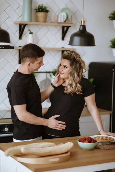 couple in love in the kitchen pregnant