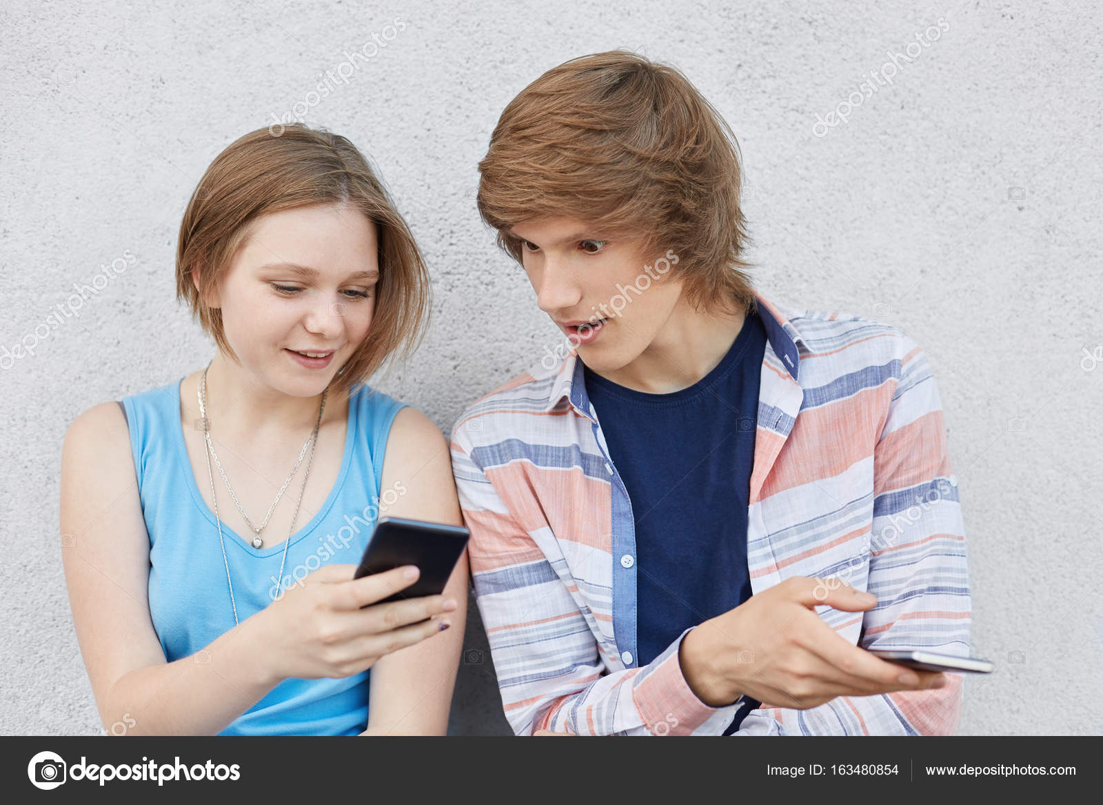 Teenage Girl With Trendy Hairstyle Wearing Blue Dress Holding Her