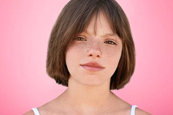 Close up portrait of freckled stylish small kid looks with narrow dark eyes directly into camera, has serious expression, isolated over pink studio background. Children, beauty, lifestyle concept — Stock Photo, Image