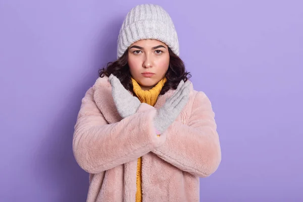 Disappointed upset outraged brunette making gesture, crossing her arms, showing protest, looking directly at camera, having unpleasant facial expression, wearing faux fur coat. Animal protection. — 스톡 사진