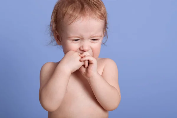 Horizontal tiro de bebê bonito em fralda chorando isolado sobre fundo estúdio azul, mantendo as mãos perto da boca, quer beber leite e adormecer, doesent quer banho. Conceito de infância . — Fotografia de Stock