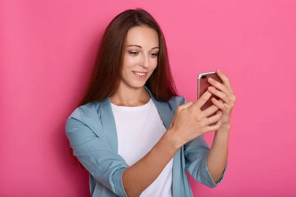 Indoor Picture Delighted Sweet Lovely Young Lady Holding Smartphone Both — Stock Photo, Image