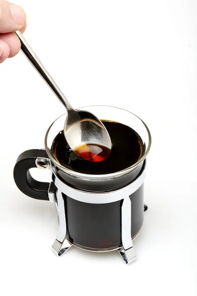 Cup of dark coffee with spoon — Stock Photo, Image