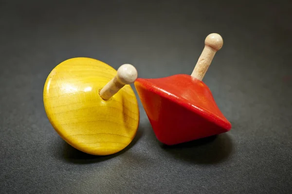 Two wooden and colorful spinning tops — Stock Photo, Image