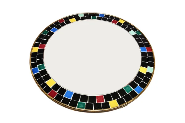 A round mirror surrounded by ceramic pieces