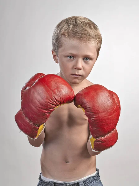 Caucasian kid with red and yellow gloves — Stock Photo, Image