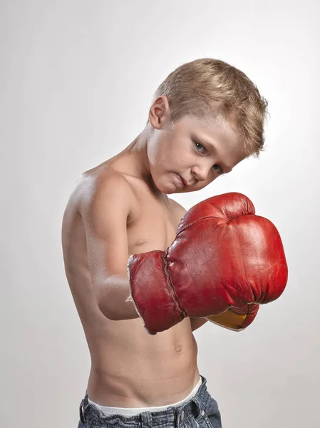 Caucasian kid with red and yellow gloves — Stock Photo, Image
