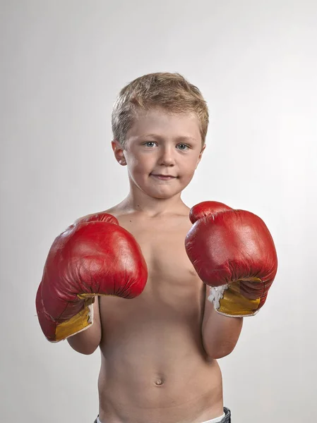 Caucasian kid with red and yellow gloves — Stock Photo, Image