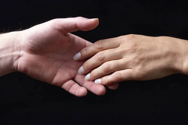 Mužské a ženské ruce na černém pozadí — Stock fotografie
