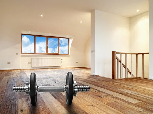 Interior with wooden floor and dumbbells in foreground — Stock Photo, Image