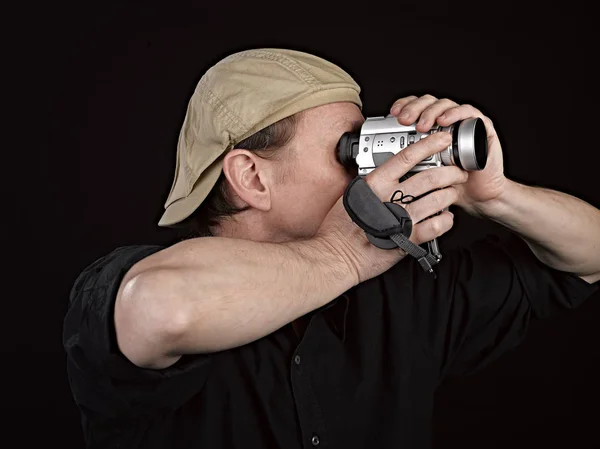Portrait of a videographer with his camera in studio — Stock Photo, Image