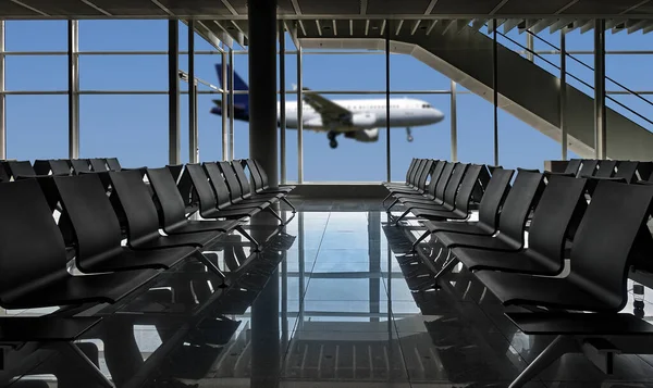 Rows of black chairs at airport and plane landing, There is a path for all windows