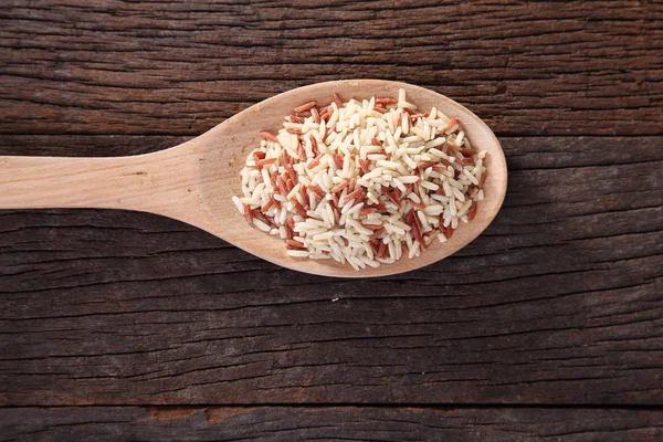 Raw rice in spoon — Stock Photo, Image