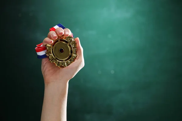 Hand holding medal — Stock Photo, Image