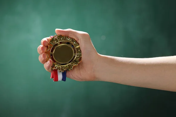 hand holding medal