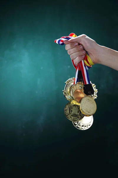 hand holding medals