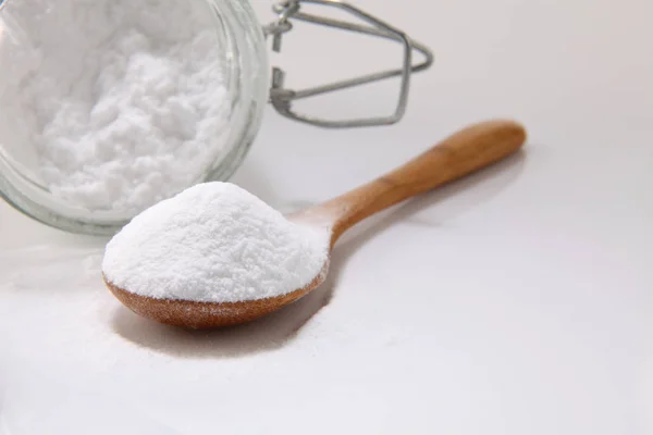 Wooden spoon with baking soda — Stock Photo, Image