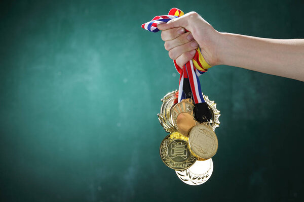 hand holding medals