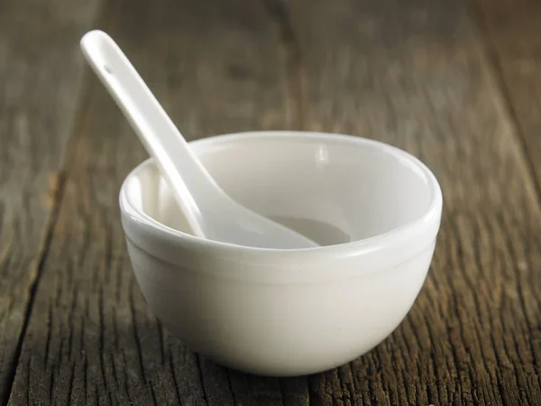 White bowl and spoon — Stock Photo, Image