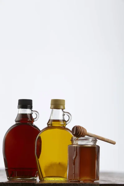 Syrups in bottles and honey — Stock Photo, Image