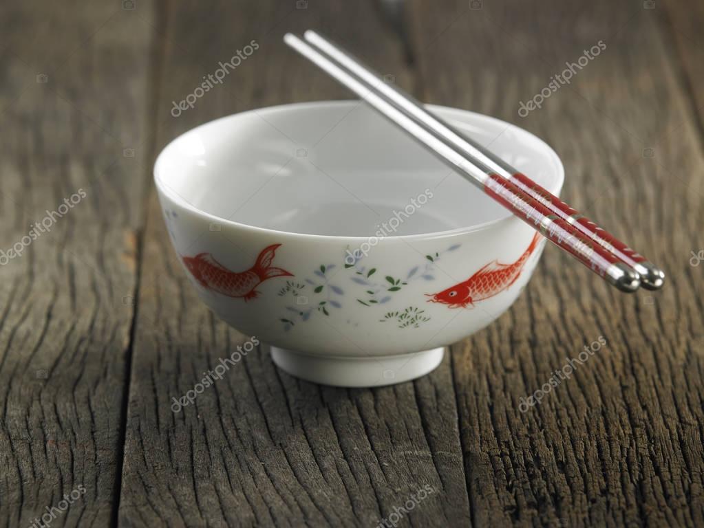 Chinese bowl with chopsticks — Stock Photo © eskaylim 138924570