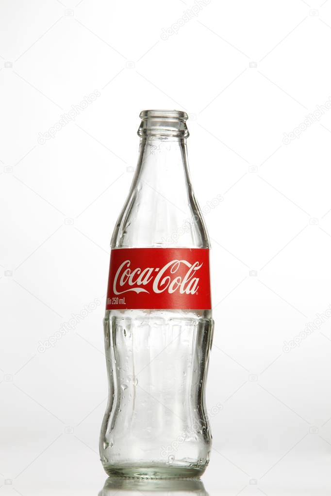 Kuala Lumpur, Malaysia - 18th July 2016: empty coca cola glass bottle on the white background