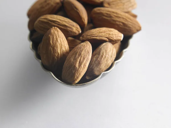 Almond seeds in spoon — Stock Photo, Image