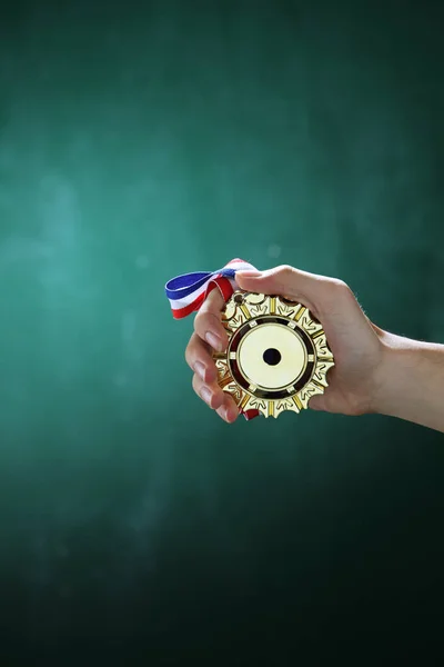 Hand holding medal — Stock Photo, Image