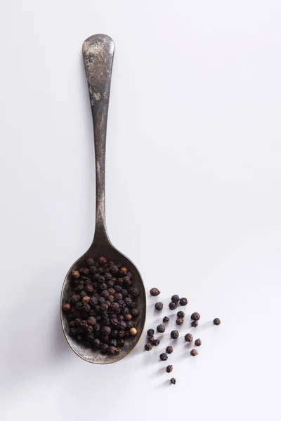 Peppercorn grains in spoon — Stock Photo, Image