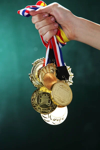 Hand holding medals — Stock Photo, Image