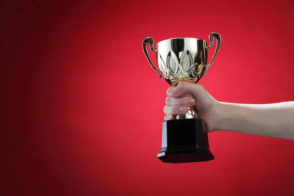 Sports trophy in hand — Stock Photo, Image