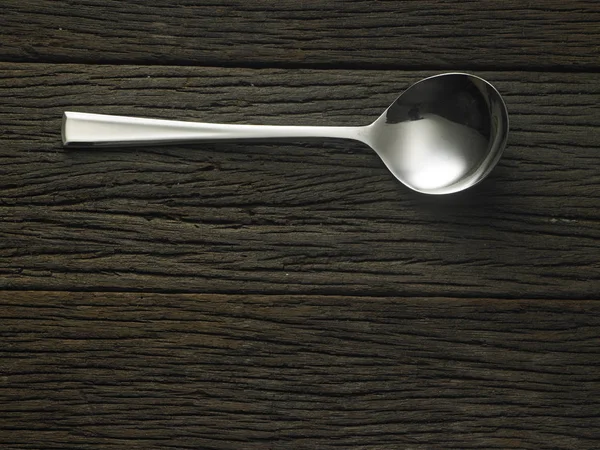 Spoon on wooden table — Stock Photo, Image
