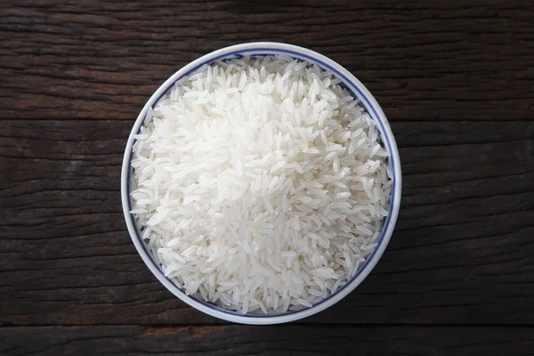 Raw rice in bowl — Stock Photo, Image